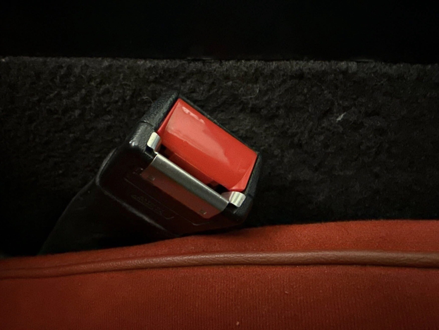 Restored seatbelt buckle with new red button — tap to enlarge
