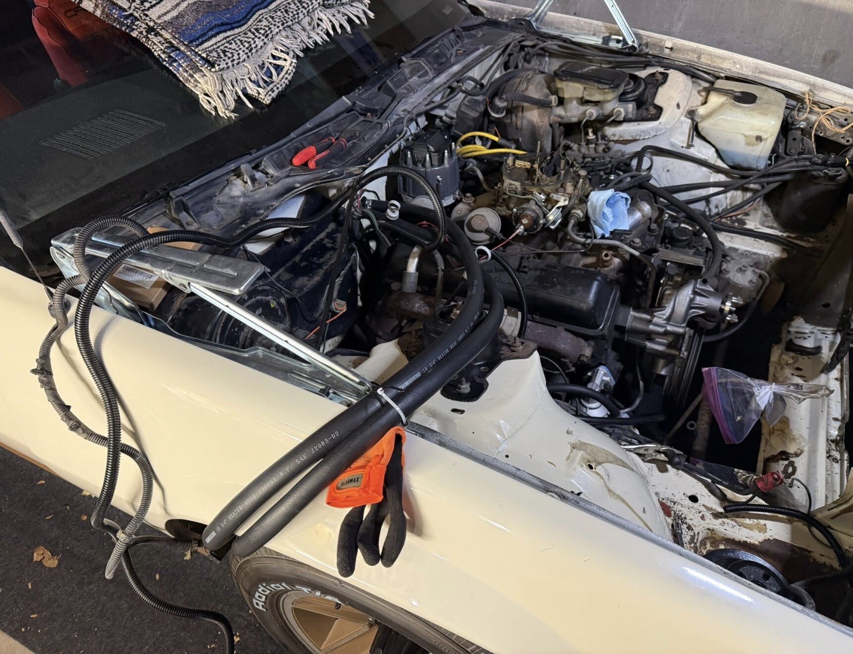 Jenny's engine bay mid-work with new hoses — tap to enlarge