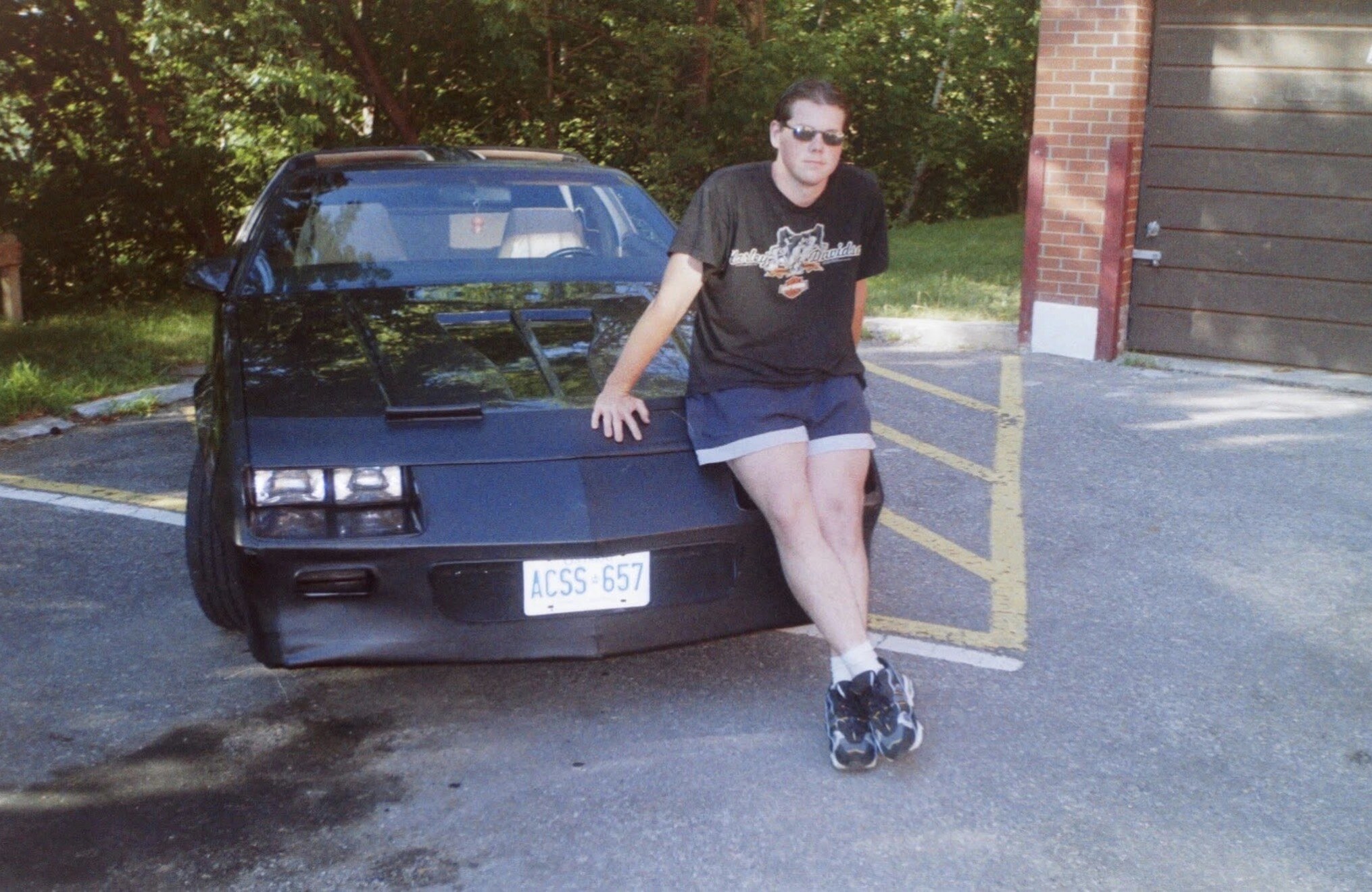 Meathead leaning on the old black Camaro — tap to enlarge