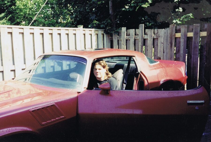 In the driver's seat with the door open