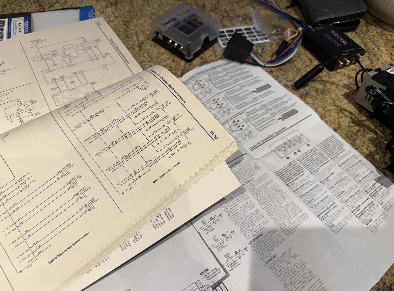 Chilton manual and radio paperwork with harnesses on the counter