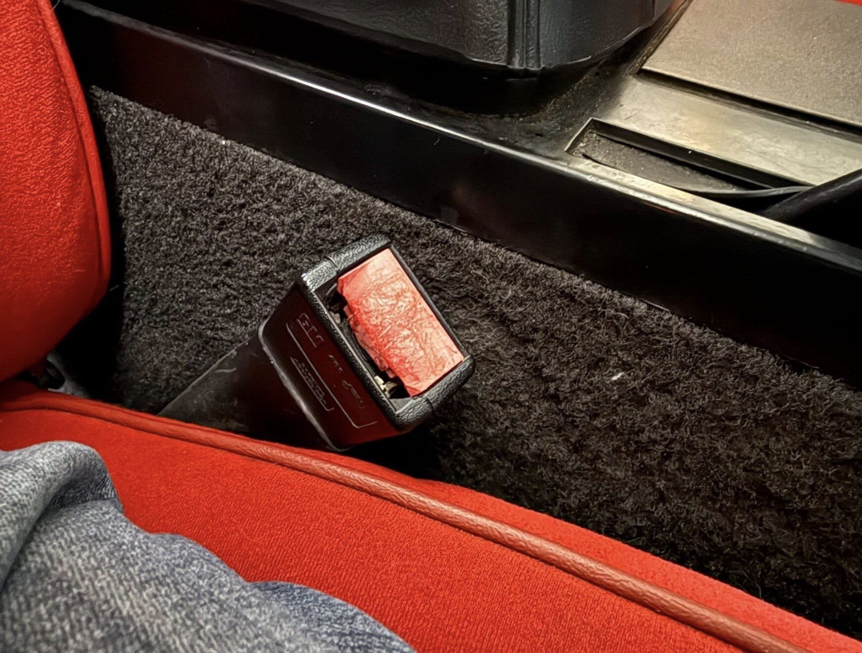 Worn seatbelt latch before repair